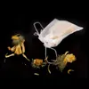 A tea bag and dried flowers on a black background. Anteprima dell’immagine prodotto