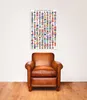 A poster of flags of the world hangs on a wall above a leather armchair. Náhled obrázku produktu