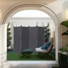 An outdoor patio area with a gray four-panel room divider, a chair, and an ottoman. Voir les images du produit