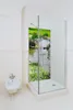 A modern bathroom with a glass shower enclosure featuring a scenic nature print. Produktbild-Vorschau