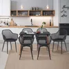 A modern kitchen and dining area with a set of black dining chairs around a black table. Voir les images du produit