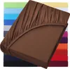 A stack of colorful fitted sheets with a brown one prominently displayed in the foreground. Produktbild-Vorschau