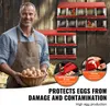A farmer holding a basket of eggs in front of a chicken nesting box. Náhled obrázku produktu