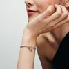 A close-up shot of a woman's arm wearing a Pandora bracelet with two charms. Anteprima dell’immagine prodotto