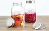 Two Kilner fermentation jars filled with vegetables and brine, placed on a wooden surface. Podgląd zdjęcia produktu