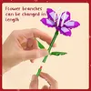 Hands assembling a building block flower. Produktbild-Vorschau