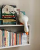 A white duck figurine is placed on a shelf next to books and an abacus. Podgląd zdjęcia produktu