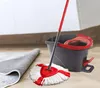 A mop and bucket set on a wooden floor next to a rolled-up rug. Produktbild-Vorschau