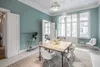 A dining room with a table and chairs, decorated with plants and a large window. Anteprima dell’immagine prodotto