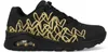 A side view of a black Skechers sneaker with gold heart detailing. Voir les images du produit