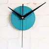 A close-up shot of a turquoise clock face with black hands, mounted on a white brick wall. Produktbild-Vorschau