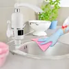 A person wearing blue gloves is cleaning a kitchen sink with a pink cloth, with a white electric hot water tap in the background. Náhled obrázku produktu