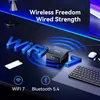 A dark desk setup with a mini PC, keyboard, phone, and wireless earbuds, illuminated by blue LED lighting. Produktbild-Vorschau
