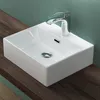 A white ceramic sink with a chrome faucet sits on a wooden surface against a teal wall. Produktbild-Vorschau