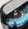 A cutaway view of the internal gears and mechanisms of a kitchen appliance, with blue light highlighting the moving parts. Produktbild-Vorschau