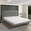 A mattress on a bed frame in a bedroom. Produktbild-Vorschau