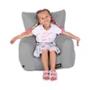 A young girl is sitting in a gray beanbag chair. Náhľad obrázku produktu