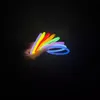 A hand holding several colorful glow sticks in the dark. Anteprima dell’immagine prodotto
