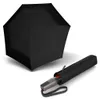 A black umbrella is shown open, with its case and handle lying next to it. Anteprima dell’immagine prodotto