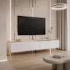 A modern white TV stand with gold accents is shown in a well-lit living room setting. Produktbild-Vorschau