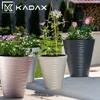 Several KADAX planters with plants are displayed on a patio. Anteprima dell’immagine prodotto