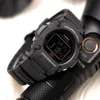 A close-up of a black Casio digital watch resting on a black flashlight. Produktbild-Vorschau