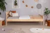 A bedroom scene with a wooden bed, pillows, blankets, and decorative items. Produktbild-Vorschau