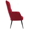 A side view of a red velvet armchair against a white background. Náhled obrázku produktu