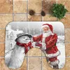 A Christmas-themed bath mat set featuring Santa Claus and a snowman. Produktbild-Vorschau