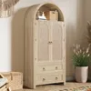 A tall, arched cabinet with woven doors and drawers, placed in a room with other decorative items. Podgląd zdjęcia produktu