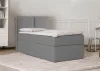 A grey upholstered bed with a headboard is shown in a room with white paneled walls and a light rug. Produktbild-Vorschau
