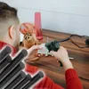 A person is using a hot glue gun to assemble a wooden owl. Voir les images du produit