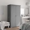A bedroom scene with a gray wardrobe, a bench with a blanket, and a vanity table with mirror and toiletries. Voir les images du produit
