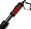 Close-up of a black and red grip on a metal rod, with a black strap attached. Podgląd zdjęcia produktu