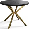 A round black dining table with a gold criss-cross base, shown from a three-quarter angle on a white background. Anteprima dell’immagine prodotto