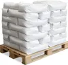 A pallet stacked with white bags of sand. Produktbild-Vorschau