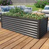 A raised garden bed filled with plants on a wooden deck, with outdoor furniture and greenery in the background. Podgląd zdjęcia produktu