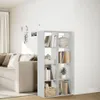 A white bookshelf is placed in a living room next to a sofa. Podgląd zdjęcia produktu