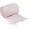 A rolled-up pink crib bumper with a white geometric pattern, lying on a white surface. Produktbild-Vorschau