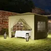 A tent set up in a garden at night with a table set for dinner inside. Podgląd zdjęcia produktu