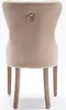 The back view of a beige upholstered dining chair with wooden legs and a decorative ring on the back. Voir les images du produit