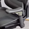 A close-up view of the armrest and seat of a black office chair. Náhled obrázku produktu