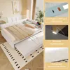A white daybed with a pull-out trundle bed, shown in a bedroom setting with decorative pillows and a rug. Inset images highlight product features like USB ports, a small night lamp, and a geometric pattern on the mattress. Podgląd zdjęcia produktu