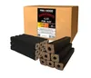 A cardboard box of wood briquettes with several briquettes stacked in front of it. Produktbild-Vorschau