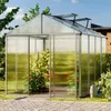 A greenhouse with plants inside, set in a garden with a paved path and watering can. Anteprima dell’immagine prodotto