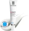 A tube of La Roche-Posay Redermic Retinol Konzentrat cream is shown against a white background with a swirl of cream. A circular overlay with a blue cross and text is present on the left. Podgląd zdjęcia produktu