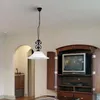 A pendant light hangs from the ceiling in a room with a television cabinet and an arched doorway. Produktbild-Vorschau