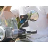 A person is riding a scooter with a phone mounted on the handlebar mirror. Náhled obrázku produktu