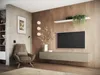 A modern living room with a TV mounted on a wooden wall, a lowboard underneath, and a comfortable armchair. Náhľad obrázku produktu