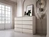 A dresser with eight drawers in a neutral-toned room with a large window and decorative elements. Náhľad obrázku produktu